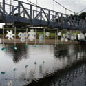 <i>Nestings</i>, 2011 Lorne Sculpture Prize. Recycled plastic, water, glass rocks, steel cable. Dimensions variable- 50mt span across bridge 